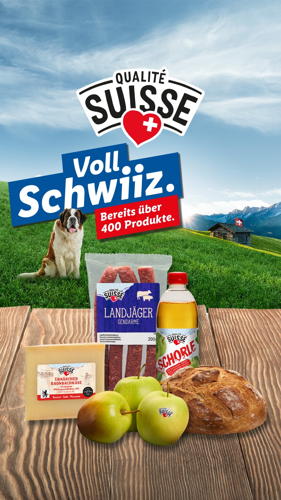 Qualitätsprodukte aus der Schweiz: Käse, Wurst, Getränk, Brot und Obst, mit Bernhardiner und Alpenlandschaft.